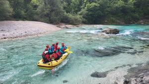 a group of people in a raft on a river at Apartment Luka at Soča & Koritnica confluence in Bovec +20 photos