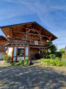 a building with a gambrel roof with a patio at Ferienhaus Eifelglühen in Monschau