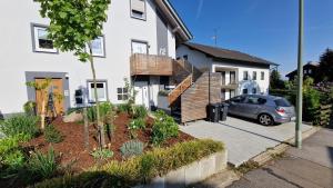 uma casa com um carro estacionado em frente em Appartment-Ferienwohnung mit Küche, Bad, kostenlos WLAN, Modern eingerichtet em Roding
