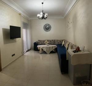 a living room with a couch and a table at Nice Apartment in Blanca Beach in Sidi Rahal