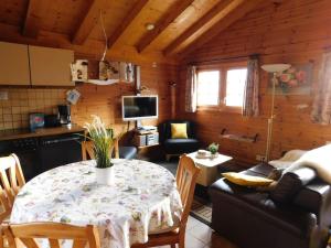 a kitchen and living room with a table in a room at Chalet Schneeflöckli in Bellwald