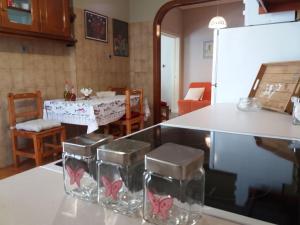a kitchen and dining room with a table and chairs at Paros Hospitality by the sea in Kampos Paros +16 photos
