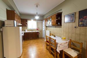 a kitchen with a table and a white refrigerator at Paros Hospitality by the sea in Kampos Paros