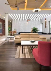 a living room with a couch and a table at Premium 5 BR full pool villa by lake close to Vagamon in Muttam