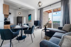 a living room with a couch and a table and chairs at Chill Out - Old Town & Seaview Apartments in Dubrovnik