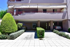 ein großes Gebäude mit Büschen davor in der Unterkunft Kostas' House luxury apartment near Volos center in Volos + 2 Fotos