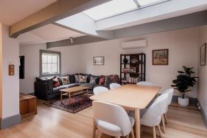 a living room with a table and a couch at Cavell Street Cottage in West Hobart in Hobart