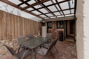 a patio with a table and chairs and a ceiling at Cavell Street Cottage in West Hobart in Hobart +42 photos