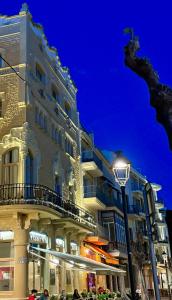 a street light in front of a building at night at Hotel Celimar in Sitges
