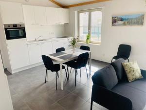 a kitchen and dining room with a table and chairs at Het Duinenhuisje in Oostduinkerke