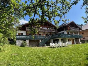 a building with white chairs in front of it at La Ferme du Château in La Chapelle-dʼAbondance +23 photos