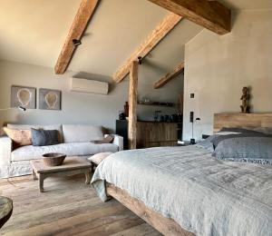 a bedroom with a bed and a couch at Strandhotel Margaretha in St. Wolfgang