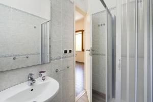 a white bathroom with a sink and a shower at Casa Spisone in Taormina
