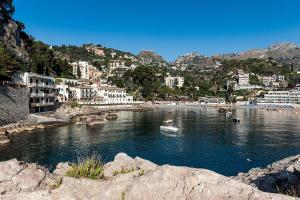 a body of water with buildings and a town at Casa Spisone in Taormina