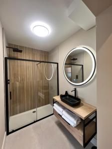 a bathroom with a shower and a sink and a mirror at The Glen Quarter in Kinsale +39 photos