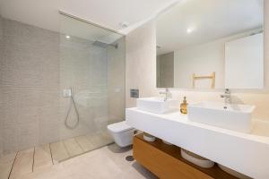 Un baño con dos lavabos y una ducha. en Luxury House Chaparral Golf E48 by AORA STAY, en La Cala de Mijas