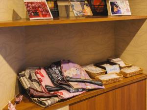 a shelf with towels and other items on it at Giappo Franca Kyoto in Kyoto