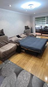 two beds in a room with a large mattress at Sweet Home in Tashkent