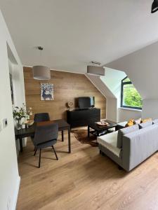 a living room with a couch and a table at JÁNOŠÍK Apartmány in Terchová