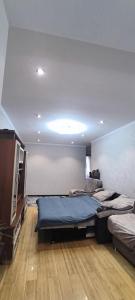 a bedroom with two beds and a flat screen tv at Sweet Home in Tashkent +2 photos