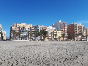 a view of a beach with buildings in the background at Apartamento Junto AL MAR Quesada 2 in Almería