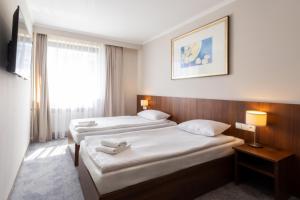 Gulta vai gultas numurā naktsmītnē Hit Hotel