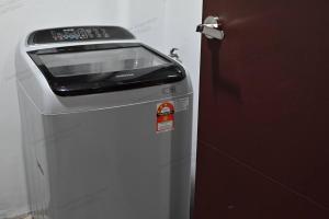 a machine sitting next to a door next to at Kuching Vivacity Jazz 1 Netflix in Kuching