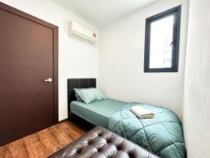 a small room with a bed and a couch at Kuching Vivacity Jazz 1 Netflix in Kuching