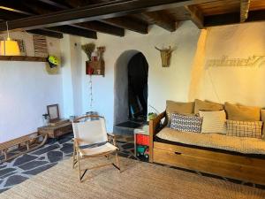 a living room with a couch and a chair at PALAU de CERDANYA I El Palauet in Palau-de-Cerdagne