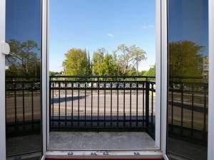 an open door with a view of a gate at B&B HOTEL Berlin-Adlershof in Berlin