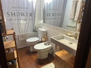 a bathroom with a white toilet and a sink at PALAU de CERDANYA I El Palauet in Palau-de-Cerdagne +44 photos