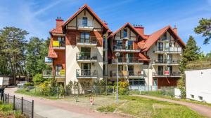 an apartment building with two turrets at Morskie Apartamenty przy plaży PIAMOLA in Krynica Morska