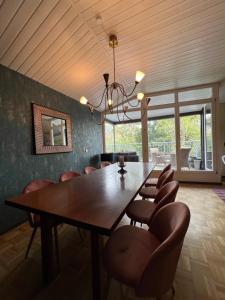 a dining room with a large wooden table and chairs at Ferienwohnungen Krügerstraße in Dresden