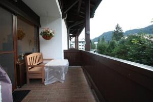 a porch with a wooden bench and a window at Ferienwohnung Hinterthal in Hinterthal