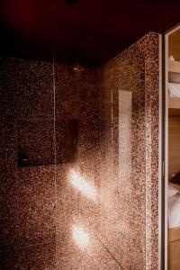 a shower with a glass door in a room at 'Sisters' - Cliff top cabin with hot tub in Spring Beach +291 photos