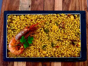 a plate of food with corn and a shrimp at Mar de Fulles in Alfondeguilla