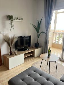a living room with a couch and a tv at Sea Viev La Mata in Torrevieja