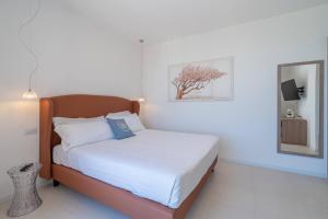 a bedroom with a bed with a tree on the wall at Dimore delle Zagare Molo in Syracuse