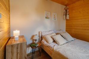 a bedroom with a bed in a wooden cabin at Podlaska chata otoczona ciszą. Na wyłączność in Kleniki