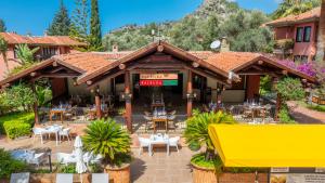 a restaurant with tables and chairs on a patio at Sundia By Liberty Suncity in Oludeniz