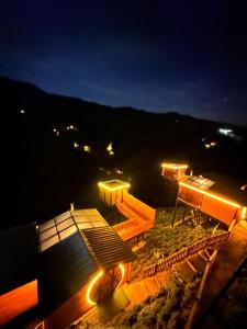 a view of a building with lights at night at Northland Bungalows in Çayırdüzü