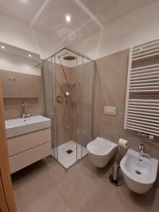 a bathroom with a shower and a toilet and a sink at Residenza Silvana in Madonna di Campiglio +204 photos
