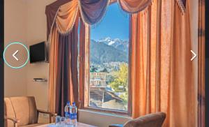 a window with a view of a mountain at Hotel Prince in Manāli +12 photos