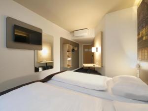 Postel nebo postele na pokoji v ubytování B&B Hotel Berlin City-West