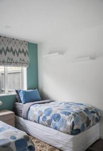 a bedroom with two beds and a window at Restful stay on Geraldine Street Suburban Beauty in Christchurch