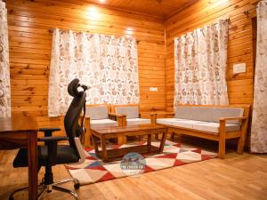 a room with wooden walls and a table and chairs at Dawat-e-Drung by FrozenFall Resort in Gulmarg