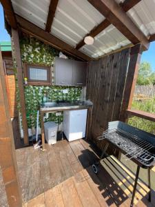 an outdoor kitchen with a table and a grill at Amazonas Beach in Ulcinj