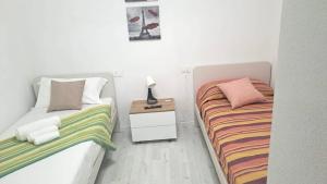 Postel nebo postele na pokoji v ubytování Il Gatto e La Volpe Foresteria Lombarda