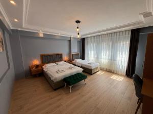 a large bedroom with two beds and a couch at ÇOLAK SUIT in Arsin