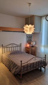 a bedroom with a bed and a chandelier at MUN Apartment City - Major Unforgettable Nights in Bergamo